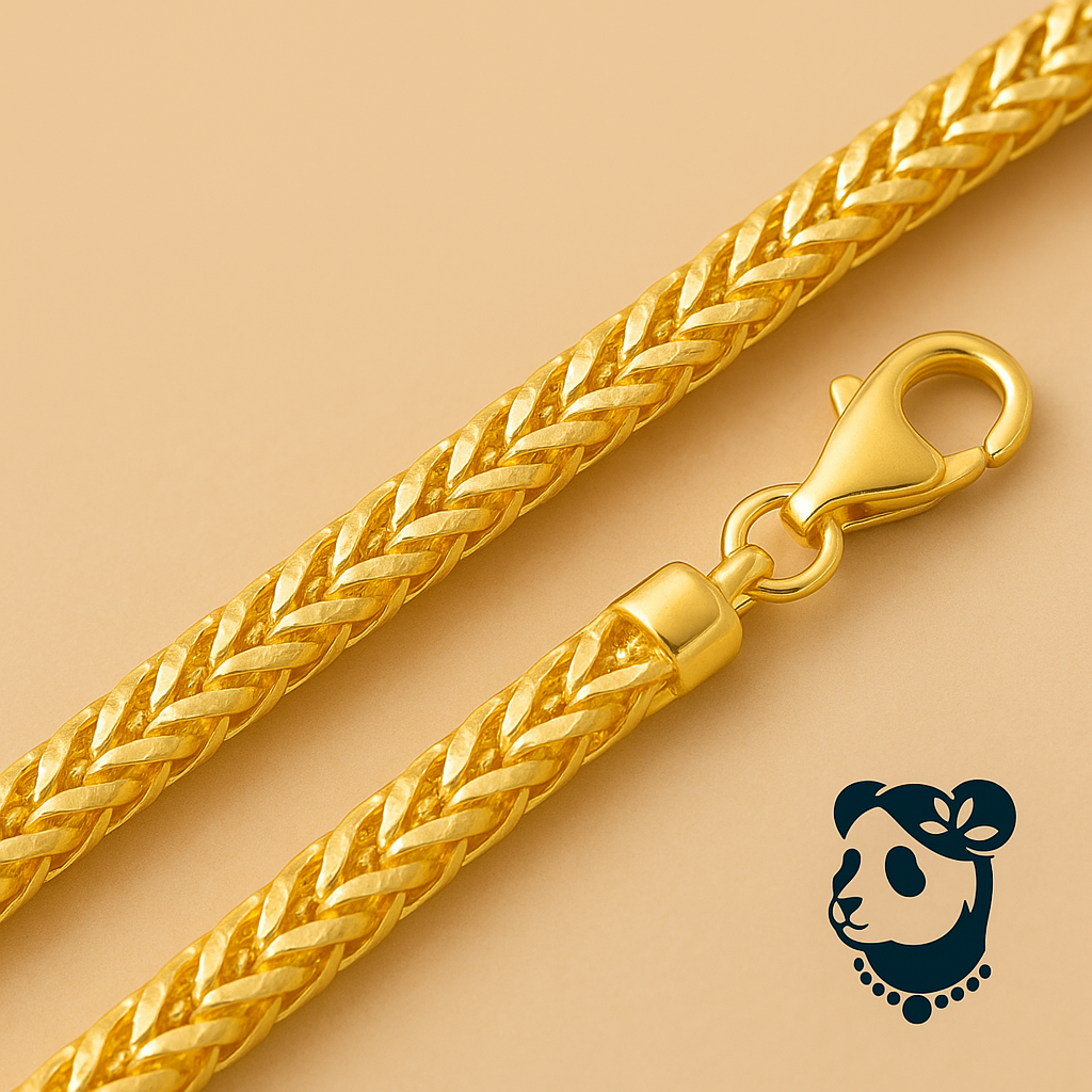 Gold braided necklace with clasp on a beige background