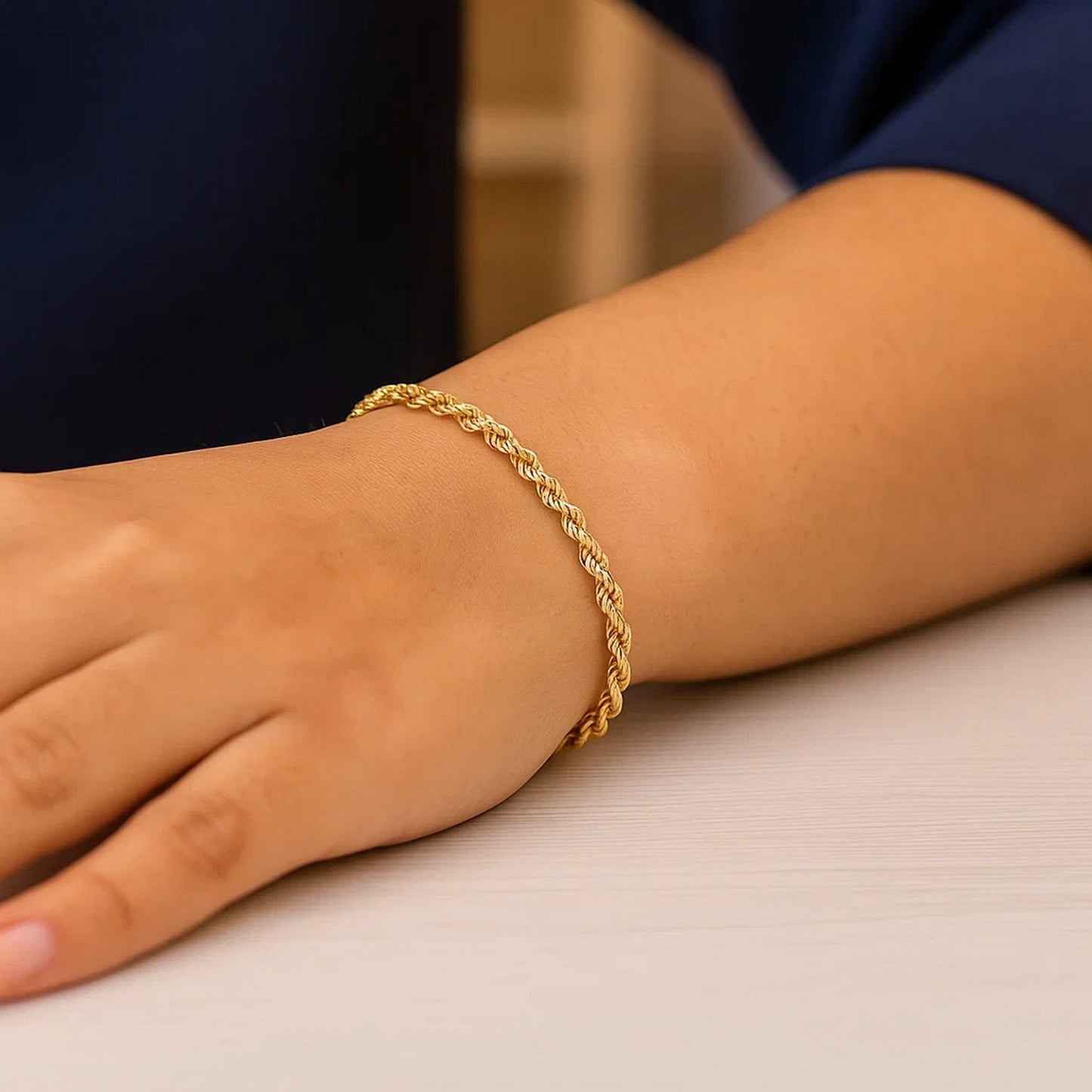 Gold bracelet on a wrist with a blurred background