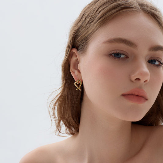 Stylish gold-plated minimalist heart earrings with an elegant, intertwined structure.