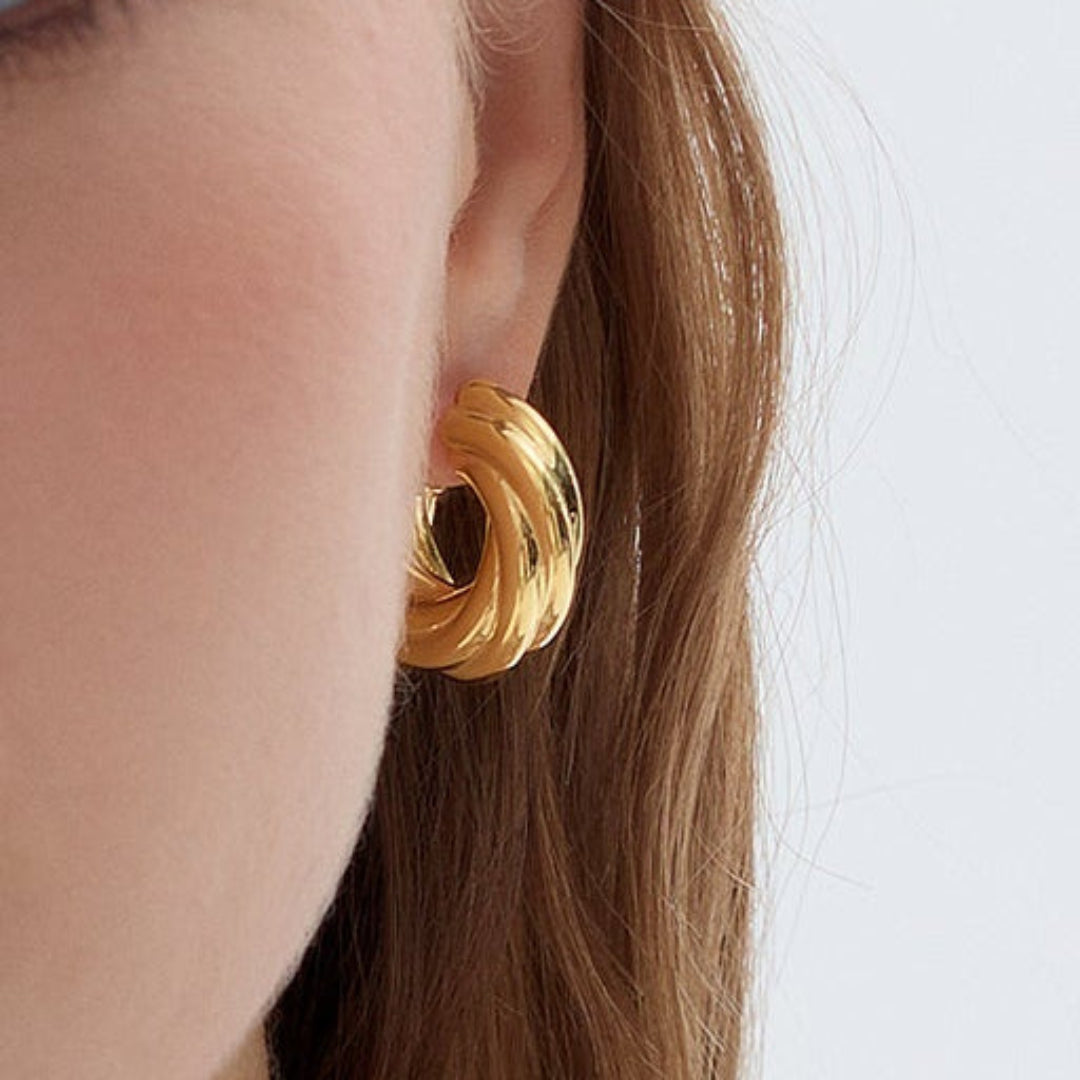 Bold gold-plated rope twist hoop earrings with a modern and elegant design.