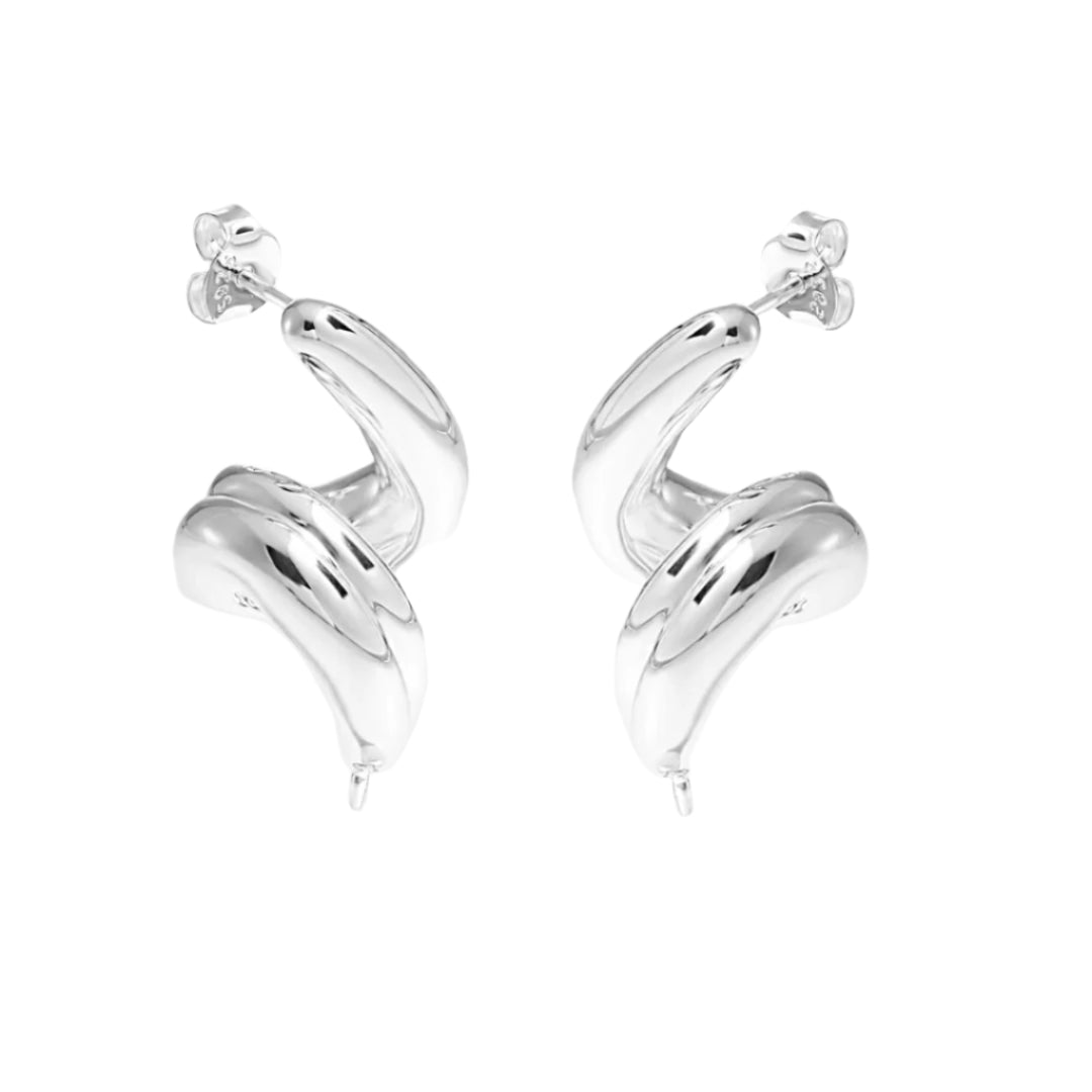 High-polish silver spiral earrings reflecting light for a bold statement.