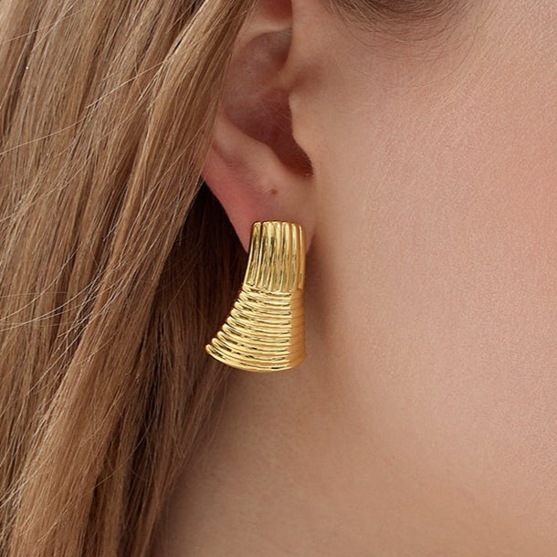 Gold-plated ribbed statement earrings with a sculptural modern design