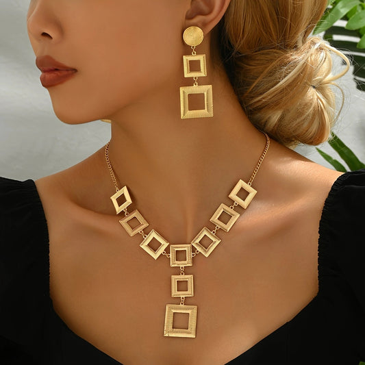 Woman wearing luxury 14K gold geometric jewelry set with square-pattern necklace and matching drop earrings.