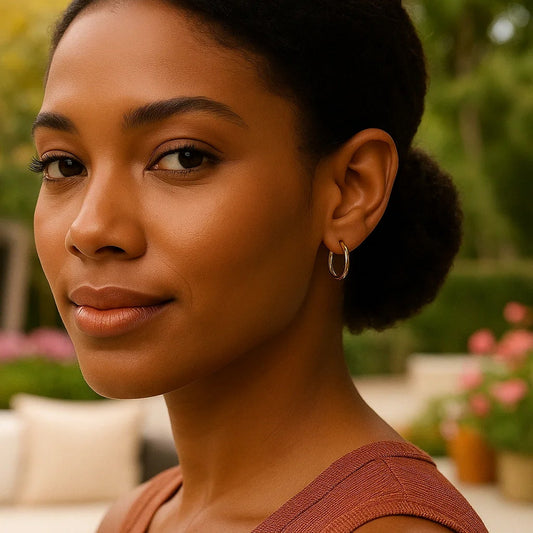 Woman with a bun hairstyle wearing hoop earrings outdoors