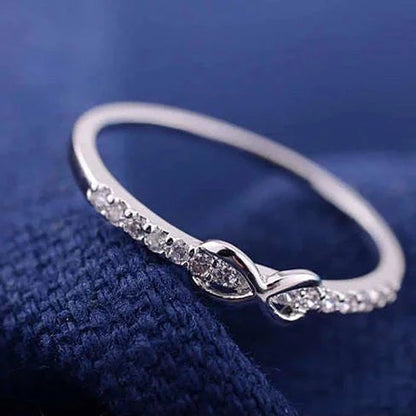 Dainty silver infinity ring with sparkling zircon stones – Elegant promise band for women.