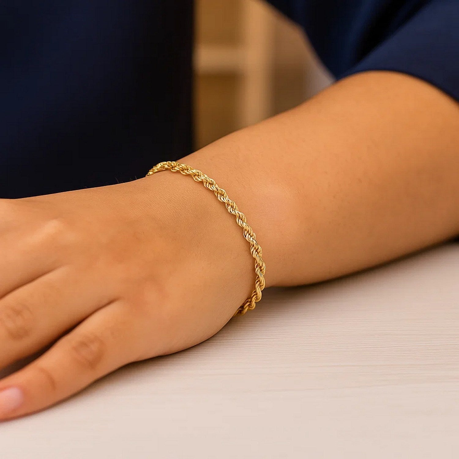 Gold bracelet on a wrist with a blurred background