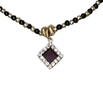 Necklace with a square pendant and black beads on a textured surface