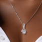Sterling silver Alluring Beauty Pendant with white and yellow gold finishes, featuring sparkling crystal accents on a delicate chain. Elegant, curved design with brilliant gemstone centerpiece, perfect for special occasions.