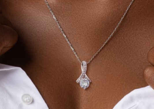 Sterling silver Alluring Beauty Pendant with white and yellow gold finishes, featuring sparkling crystal accents on a delicate chain. Elegant, curved design with brilliant gemstone centerpiece, perfect for special occasions.