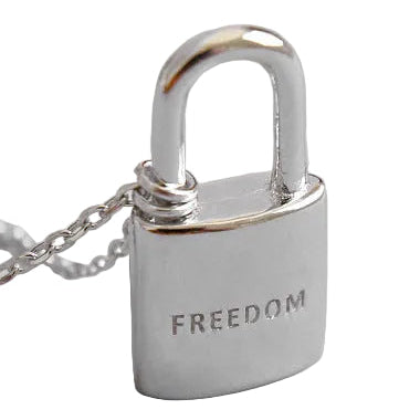 Silver padlock-shaped pendant with 'FREEDOM' engraving on a light gray background