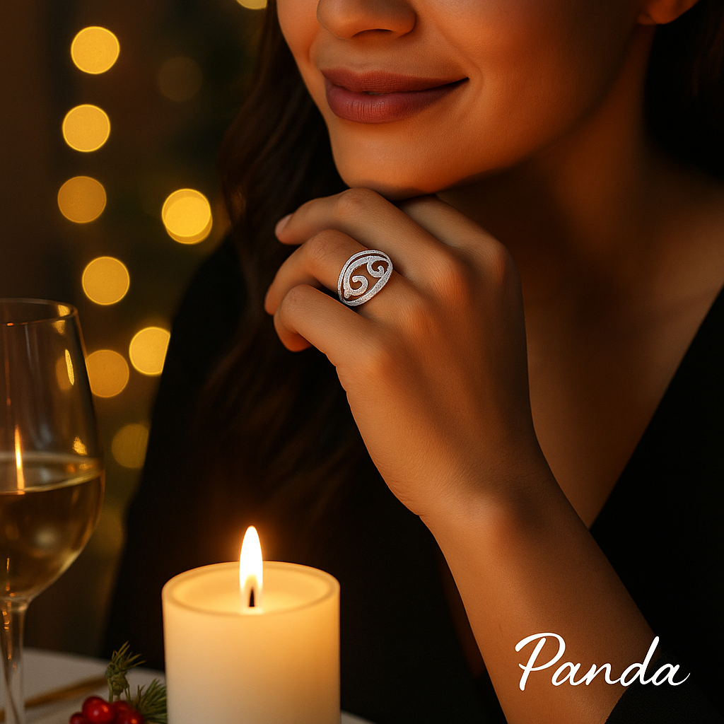 Woman wearing a Swirl diamond ring with a blurred candle and a wine glass in the background, featuring the brand 'Panda Jewelry Store'.