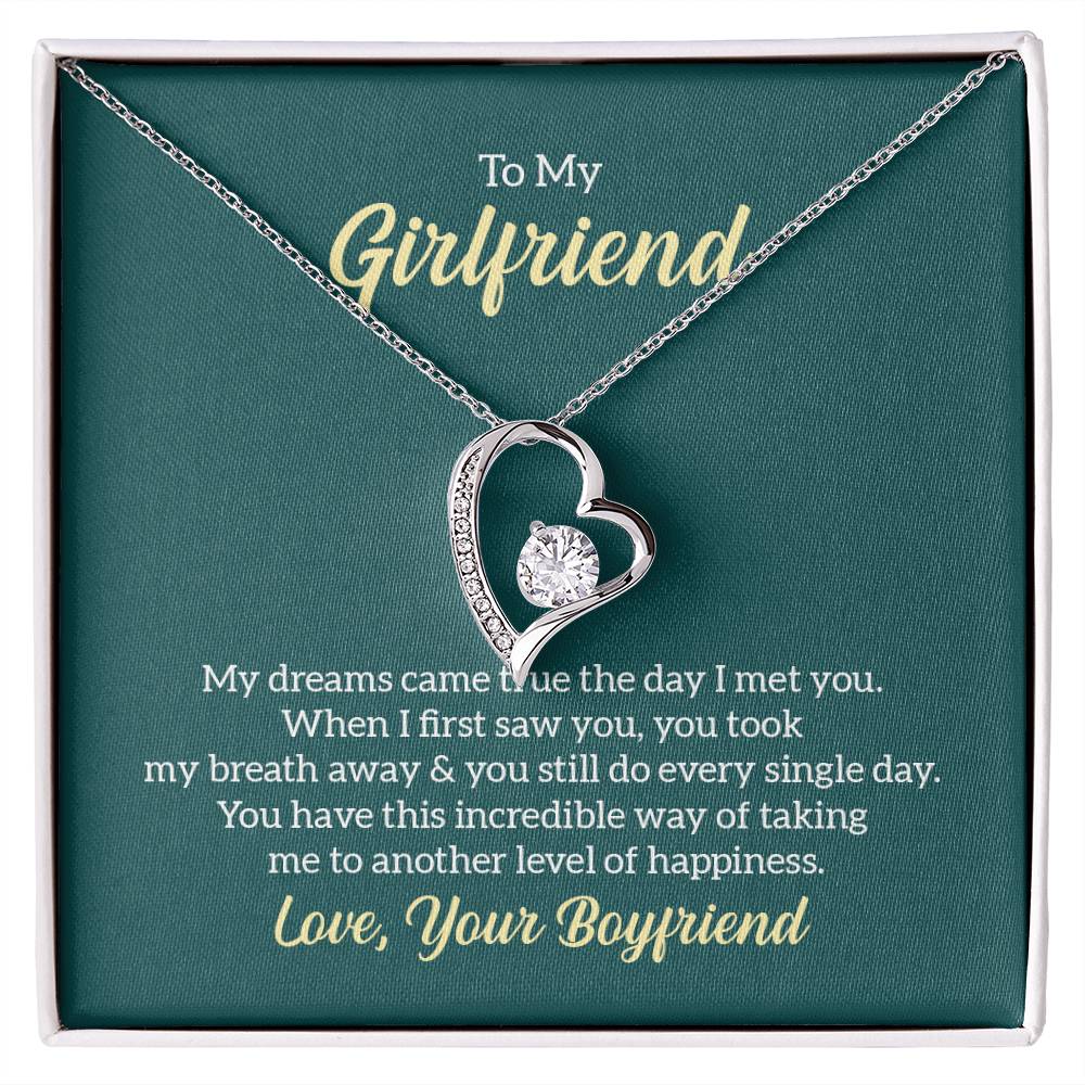 To My Girlfriend necklace with a heart-shaped pendant featuring a sparkling cubic zirconia center, displayed in a gift box with a heartfelt message from 'Your Boyfriend.'