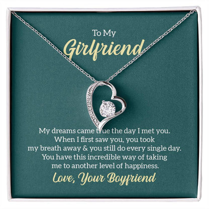 To My Girlfriend necklace with a heart-shaped pendant featuring a sparkling cubic zirconia center, displayed in a gift box with a heartfelt message from 'Your Boyfriend.'