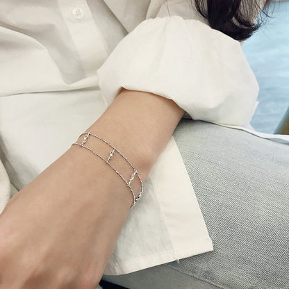 Elegant Gold Dollar Sign Bracelet – Double Chain with CZ Sparkle