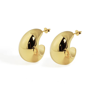 Pair of gold-plated crescent-shaped hoop earrings with a bold, sculptural design.