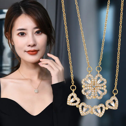 Sparkling gold necklace featuring interlocking heart pendants forming a four-leaf clover design, showcased by PandaJewelryStore.com