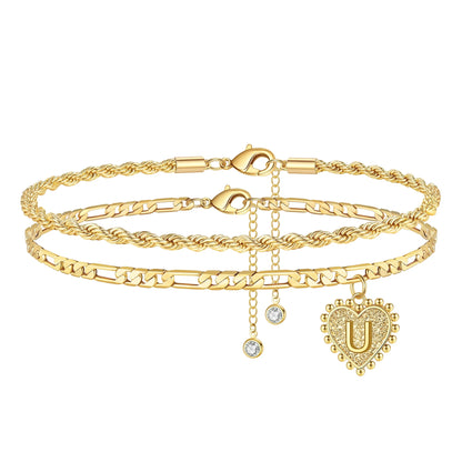 Gold layered ankle bracelet set with heart charm and crystal details.