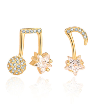 Gold earrings with star and ball designs on a white background