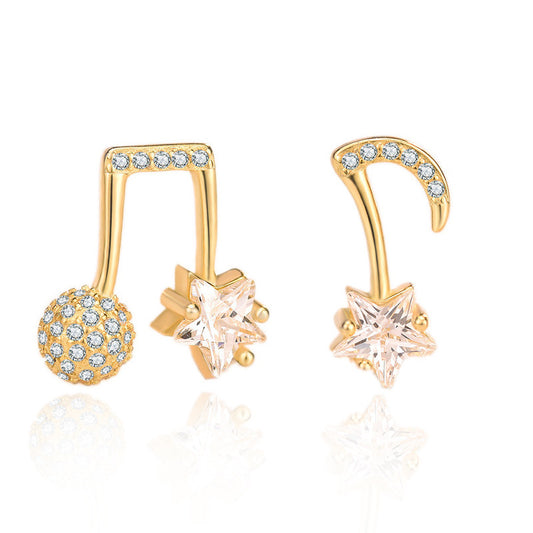 Gold earrings with star and ball designs on a white background