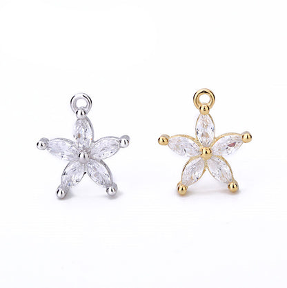 Star-shaped jewelry pendants in gold and silver on a white background