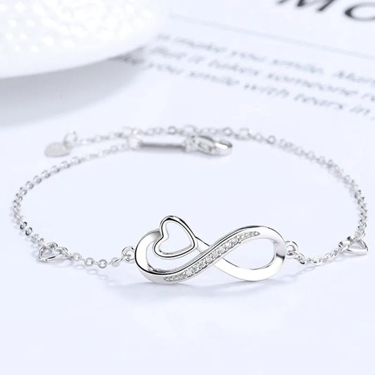 Infinity heart silver bracelet with zirconia accents on a delicate chain