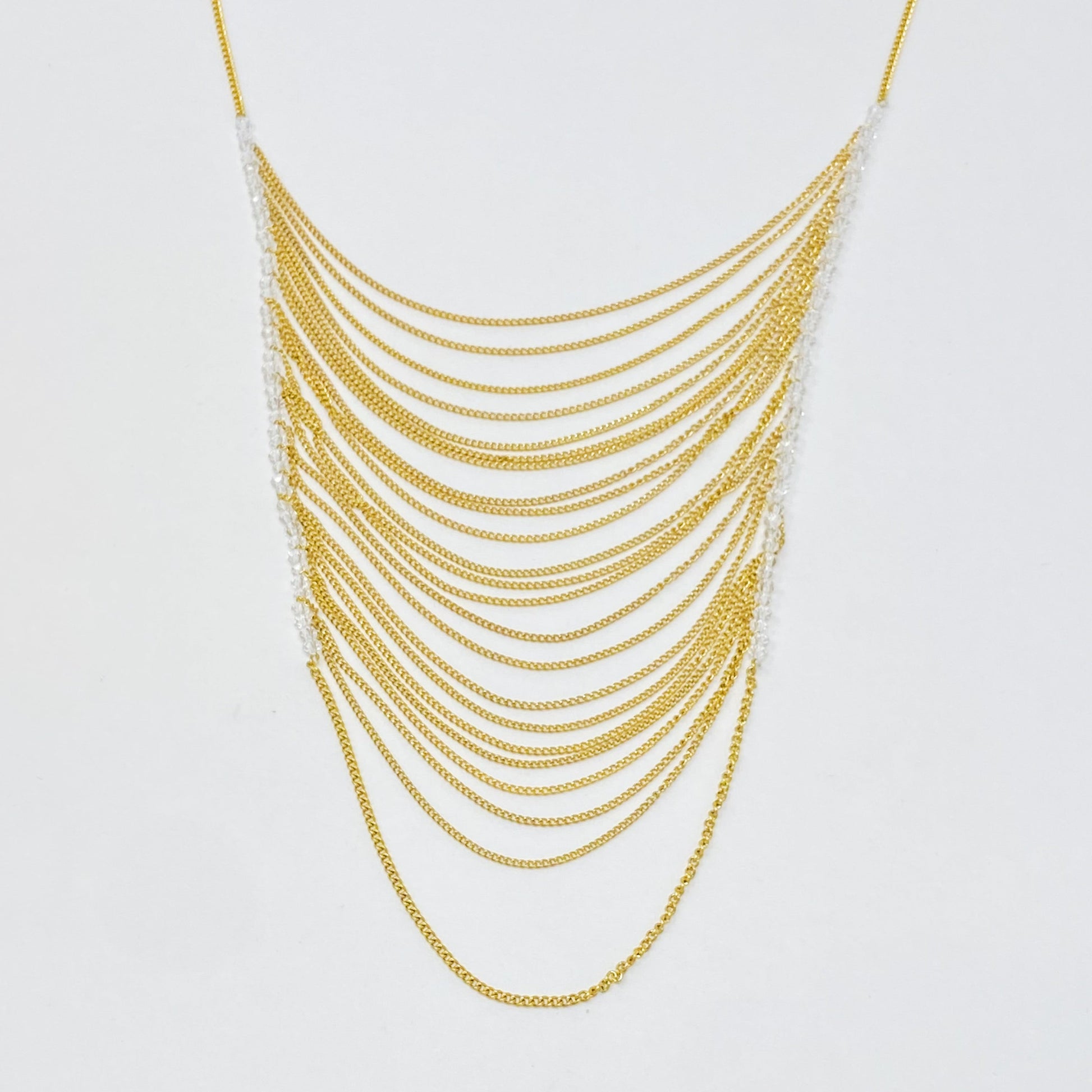 Multi-layered gold chain drop necklace with cascading arcs