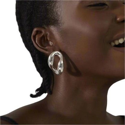 Modern silver-plated earring with an open abstract design and polished reflective finish.