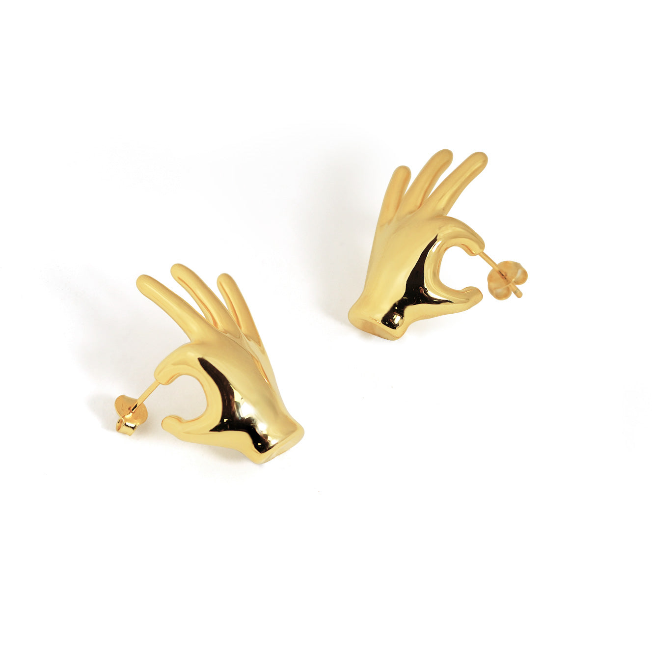 Gold hand-shaped earrings on a white background