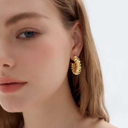 Large spiral gold-plated hoop earrings made from lightweight electroformed sterling silver.
