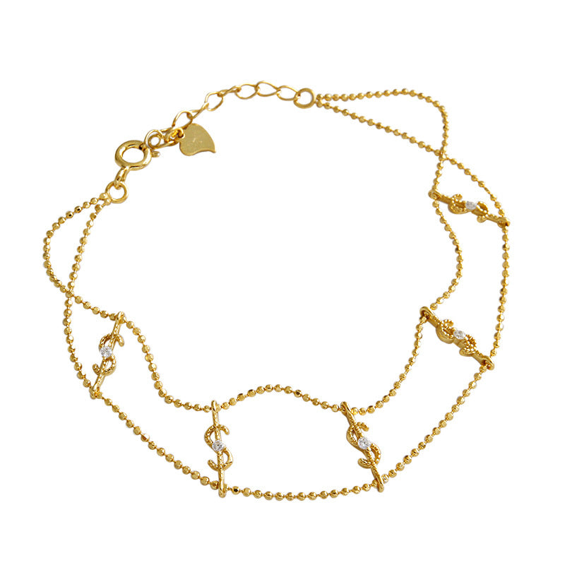 Sterling silver fashion bracelet with gold finish and sparkling dollar charms