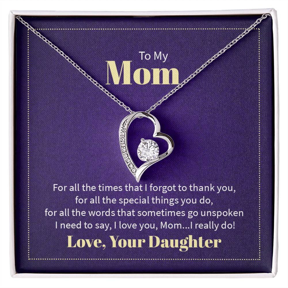 To My Mom heart-shaped necklace with a sparkling cubic zirconia center, displayed in a purple gift box with a heartfelt message from a daughter.